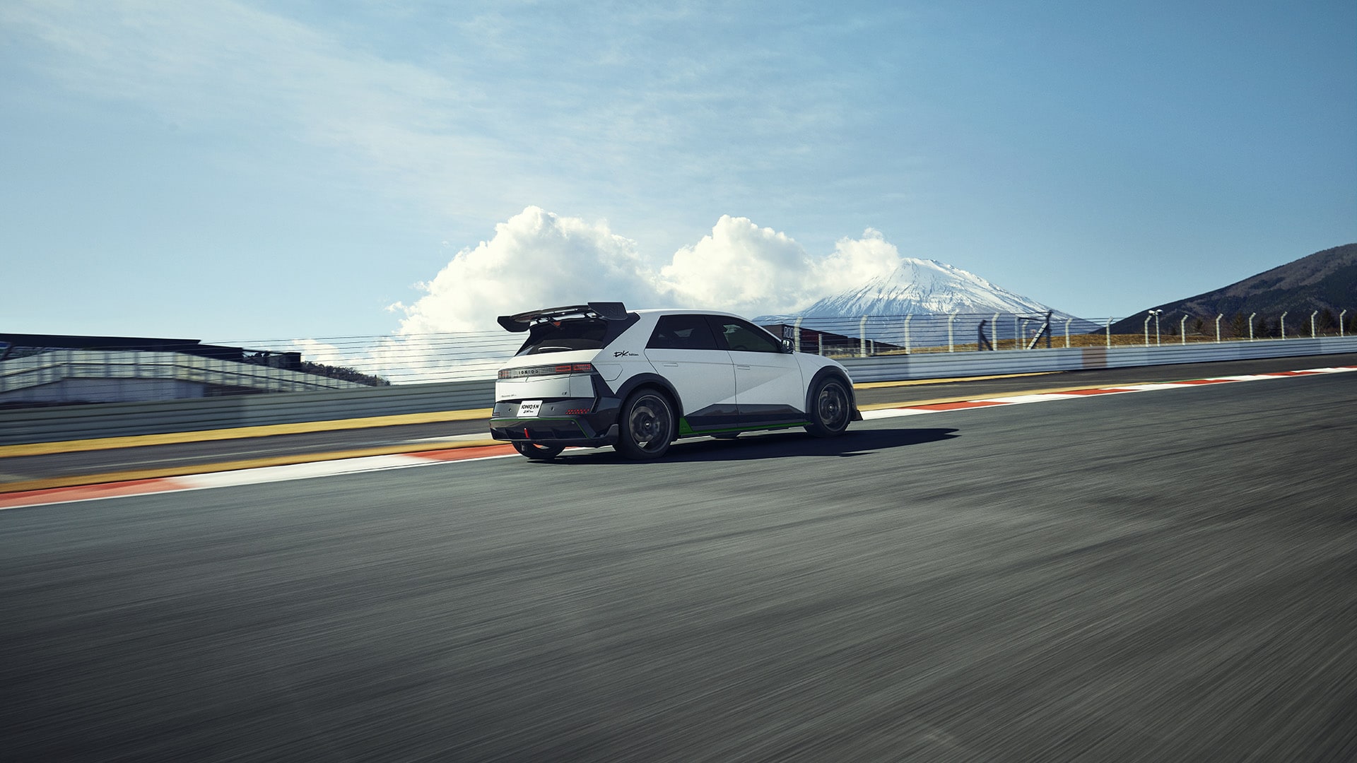 Right side view of the IONIQ 5 N DK Edition Limited Package running on a straight track.