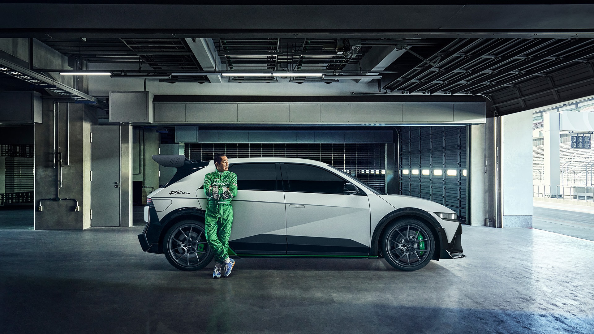A person is leaning against the right rear door of the IONIQ 5 N DK Edition Limited Package vehicle.